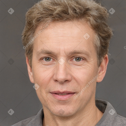 Joyful white adult male with short  brown hair and grey eyes