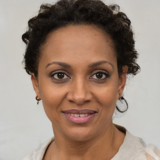 Joyful black young-adult female with short  brown hair and brown eyes