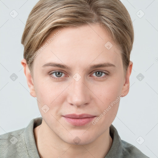 Joyful white young-adult female with short  brown hair and blue eyes