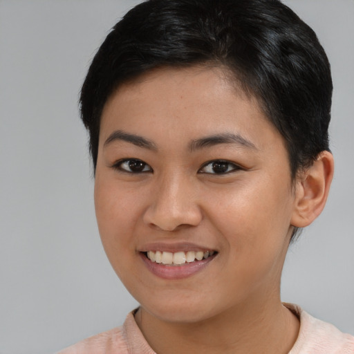 Joyful asian young-adult female with short  brown hair and brown eyes