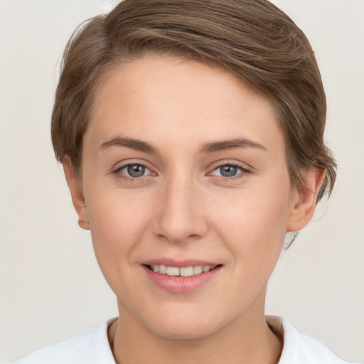 Joyful white young-adult female with short  brown hair and grey eyes