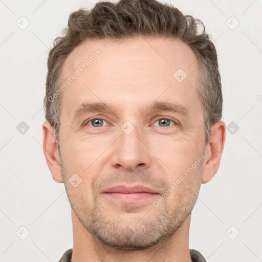 Joyful white adult male with short  brown hair and grey eyes