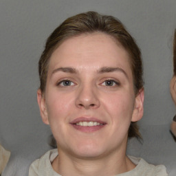 Joyful white young-adult female with medium  brown hair and grey eyes