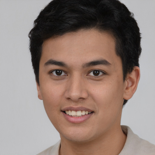 Joyful latino young-adult male with short  brown hair and brown eyes