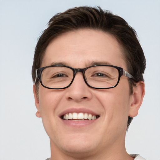 Joyful white young-adult male with short  brown hair and blue eyes