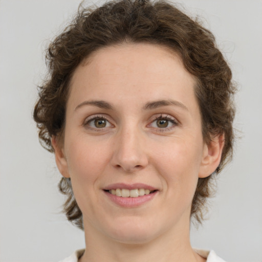 Joyful white young-adult female with medium  brown hair and green eyes