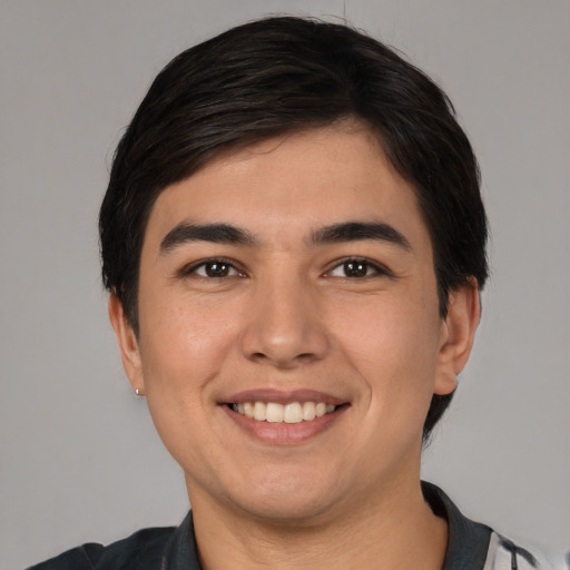 Joyful white young-adult male with short  black hair and brown eyes