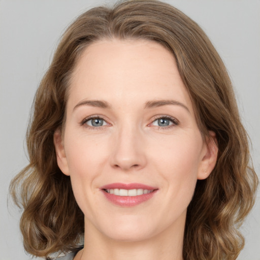 Joyful white young-adult female with medium  brown hair and green eyes