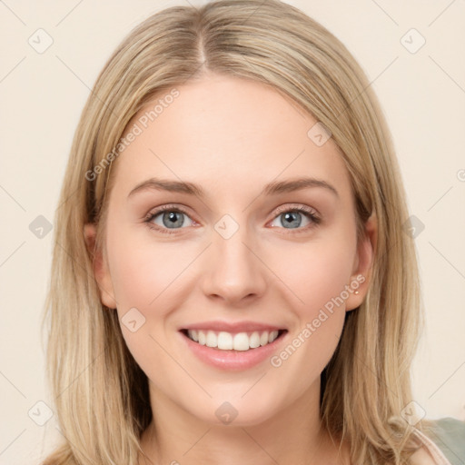 Joyful white young-adult female with long  brown hair and blue eyes