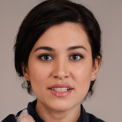 Joyful white young-adult female with medium  black hair and brown eyes