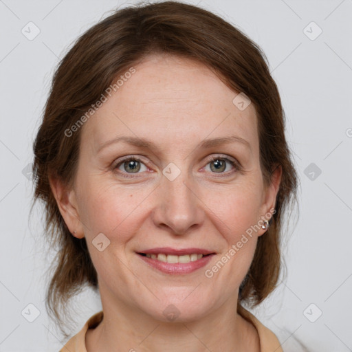 Joyful white adult female with medium  brown hair and grey eyes