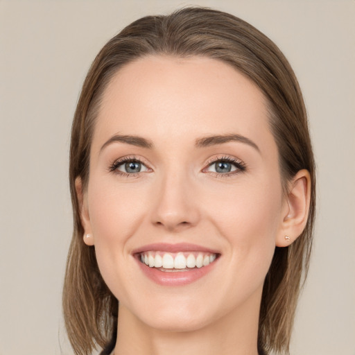 Joyful white young-adult female with long  brown hair and blue eyes