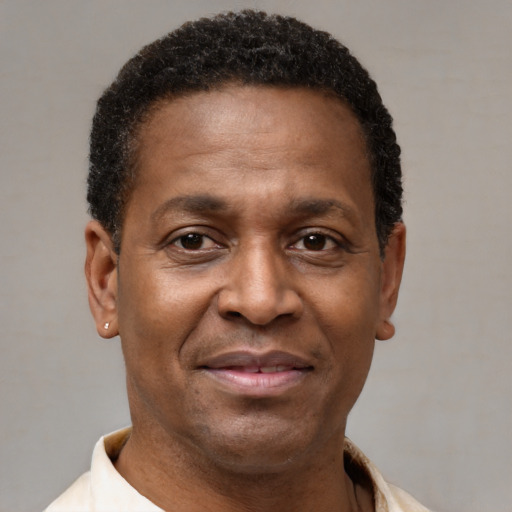 Joyful latino adult male with short  brown hair and brown eyes