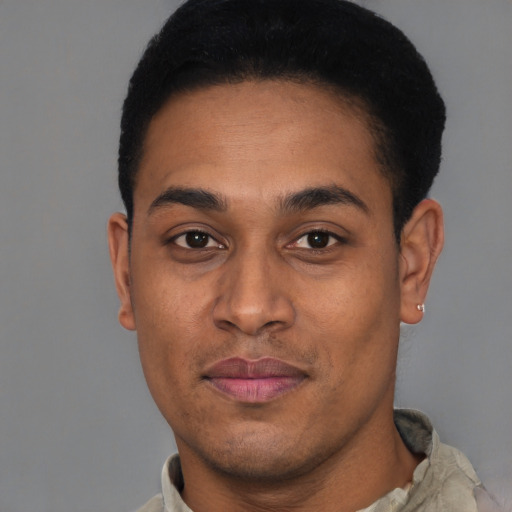 Joyful latino young-adult male with short  black hair and brown eyes