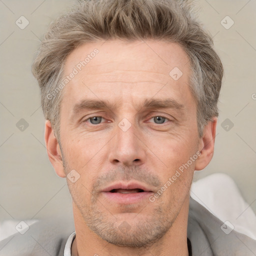 Neutral white adult male with short  brown hair and grey eyes