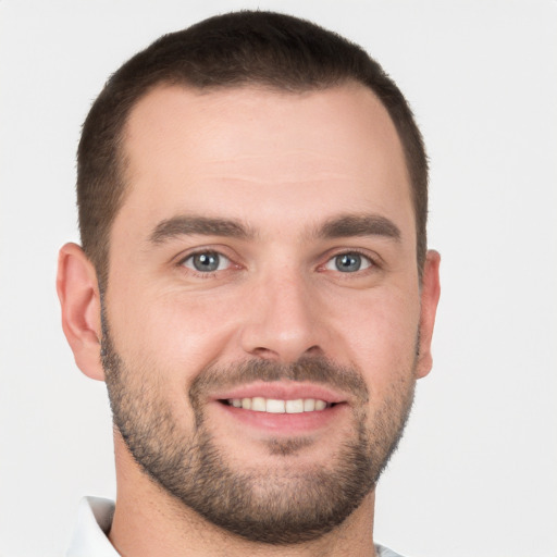 Joyful white young-adult male with short  brown hair and brown eyes