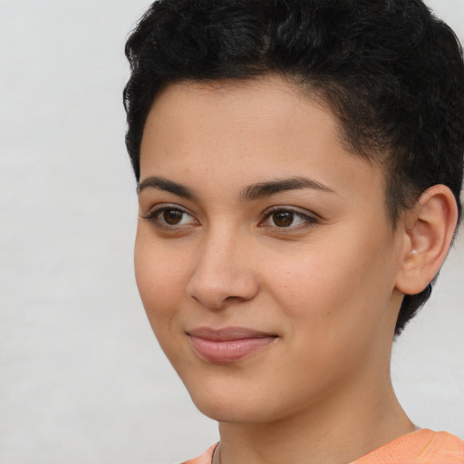 Joyful latino young-adult female with short  brown hair and brown eyes