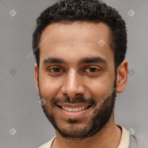 Joyful white young-adult male with short  black hair and brown eyes