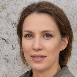 Joyful white adult female with medium  brown hair and grey eyes