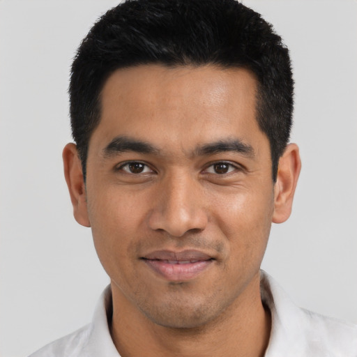 Joyful asian young-adult male with short  black hair and brown eyes