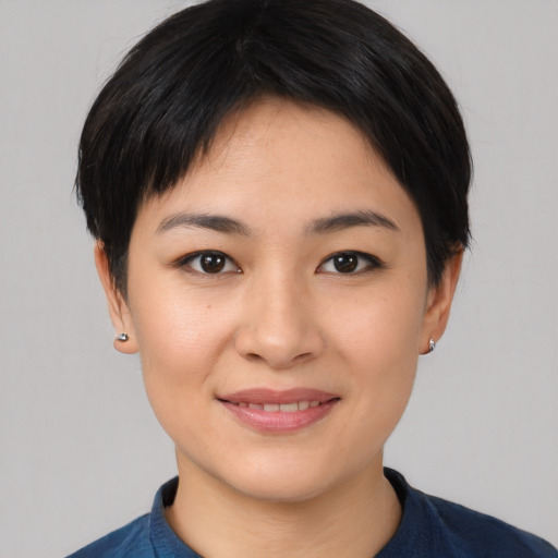 Joyful asian young-adult female with short  black hair and brown eyes
