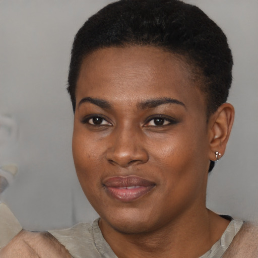 Joyful black young-adult female with short  brown hair and brown eyes