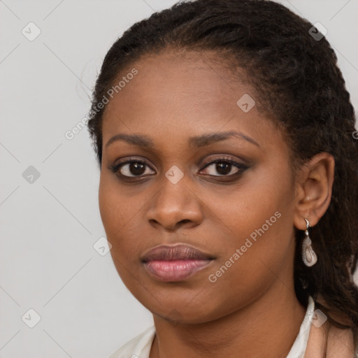 Joyful black young-adult female with long  brown hair and brown eyes