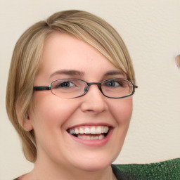 Joyful white young-adult female with medium  brown hair and green eyes