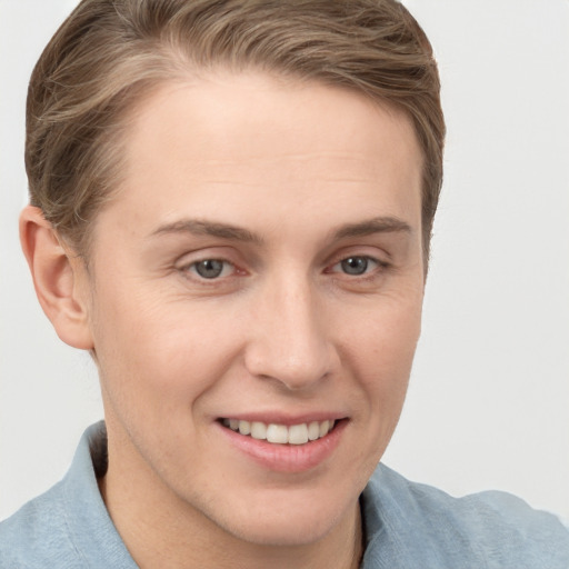 Joyful white young-adult female with short  brown hair and grey eyes