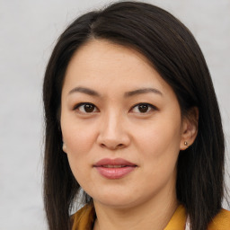 Joyful asian young-adult female with long  brown hair and brown eyes