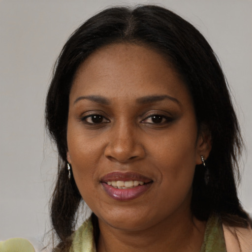 Joyful black adult female with medium  black hair and brown eyes