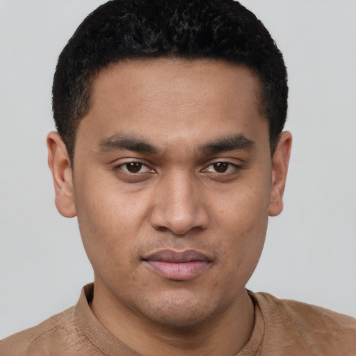 Joyful white young-adult male with short  black hair and brown eyes