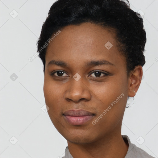 Joyful black young-adult female with short  black hair and brown eyes