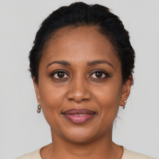 Joyful black adult female with short  brown hair and brown eyes