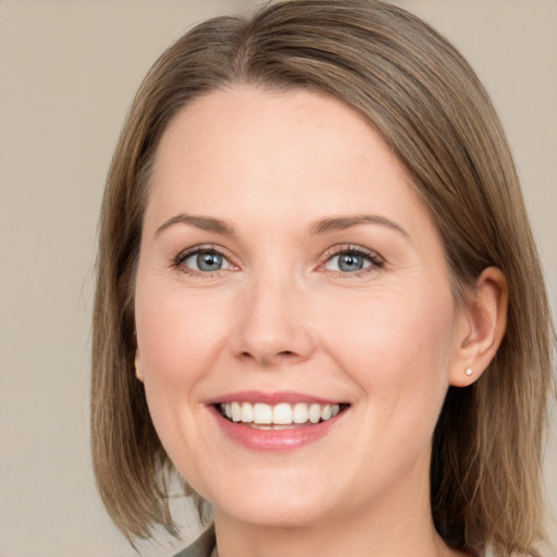 Joyful white young-adult female with medium  brown hair and green eyes