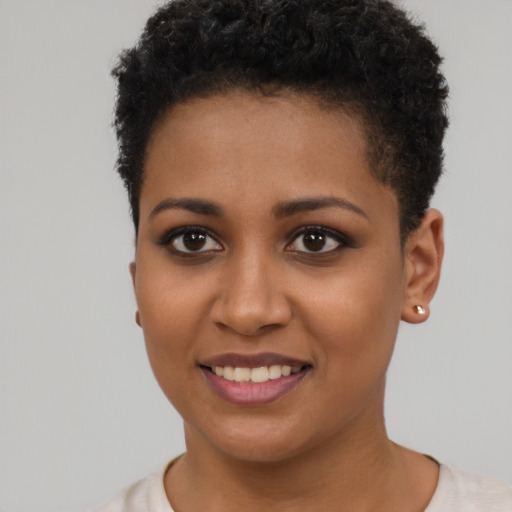 Joyful black young-adult female with short  brown hair and brown eyes