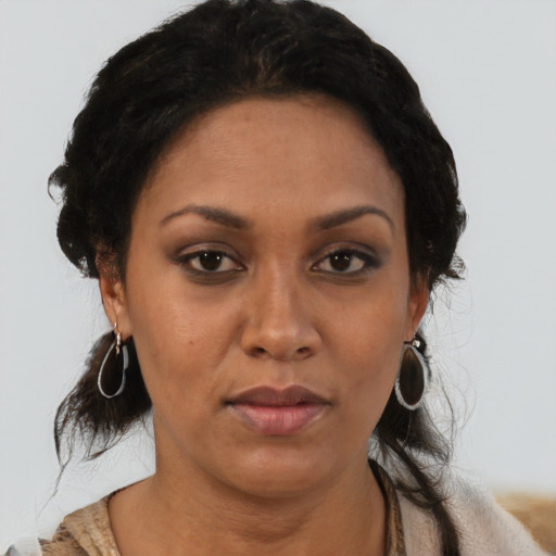 Joyful latino adult female with short  brown hair and brown eyes