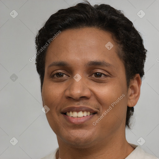 Joyful latino young-adult male with short  brown hair and brown eyes