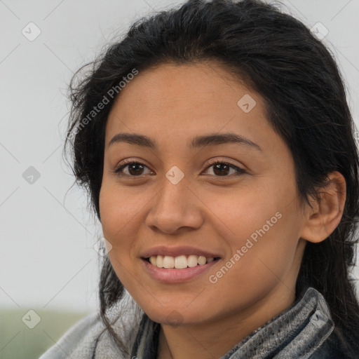 Joyful latino young-adult female with long  brown hair and brown eyes