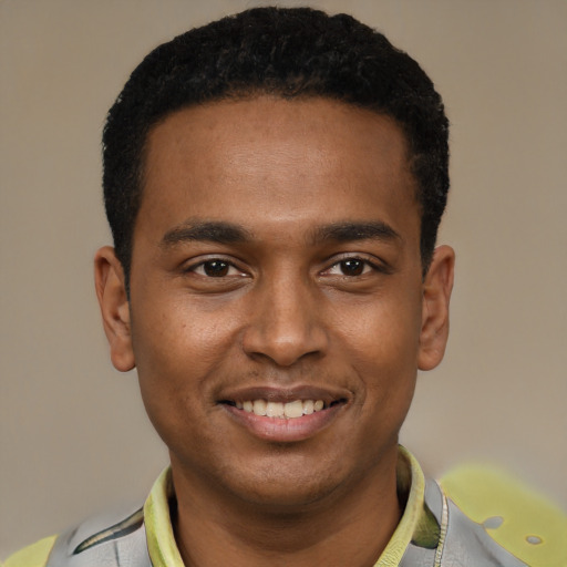 Joyful black young-adult male with short  black hair and brown eyes