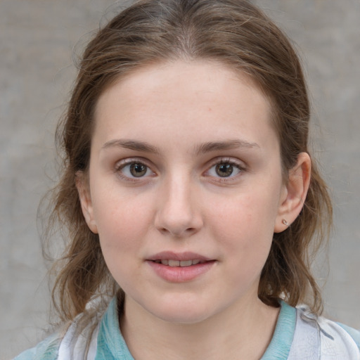 Joyful white child female with medium  brown hair and grey eyes