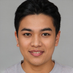 Joyful asian young-adult male with short  brown hair and brown eyes