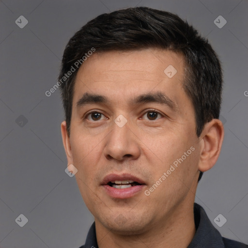 Joyful white adult male with short  black hair and brown eyes