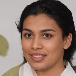 Joyful latino young-adult female with medium  black hair and brown eyes