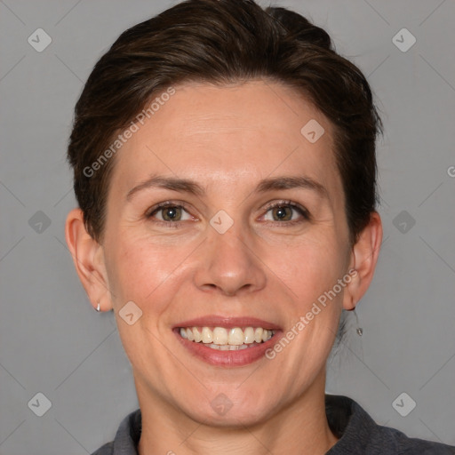 Joyful white adult female with short  brown hair and grey eyes