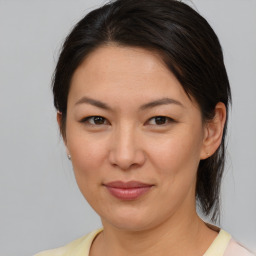 Joyful white young-adult female with medium  brown hair and brown eyes