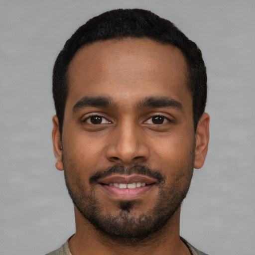 Joyful latino young-adult male with short  black hair and brown eyes