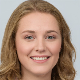 Joyful white young-adult female with long  brown hair and green eyes