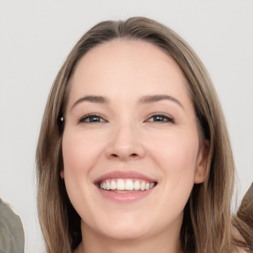 Joyful white young-adult female with long  brown hair and brown eyes