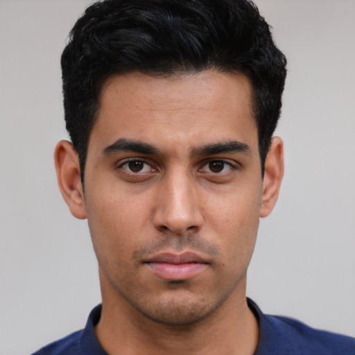 Neutral latino young-adult male with short  black hair and brown eyes